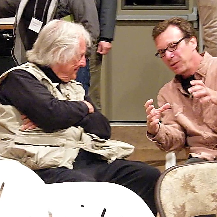 Rick Friedman and Gerry Spence in conversation, seated together at a seminar