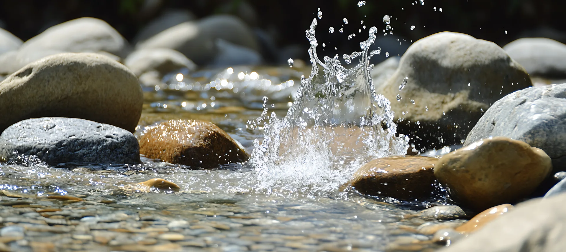 River water splashing among smooth stones